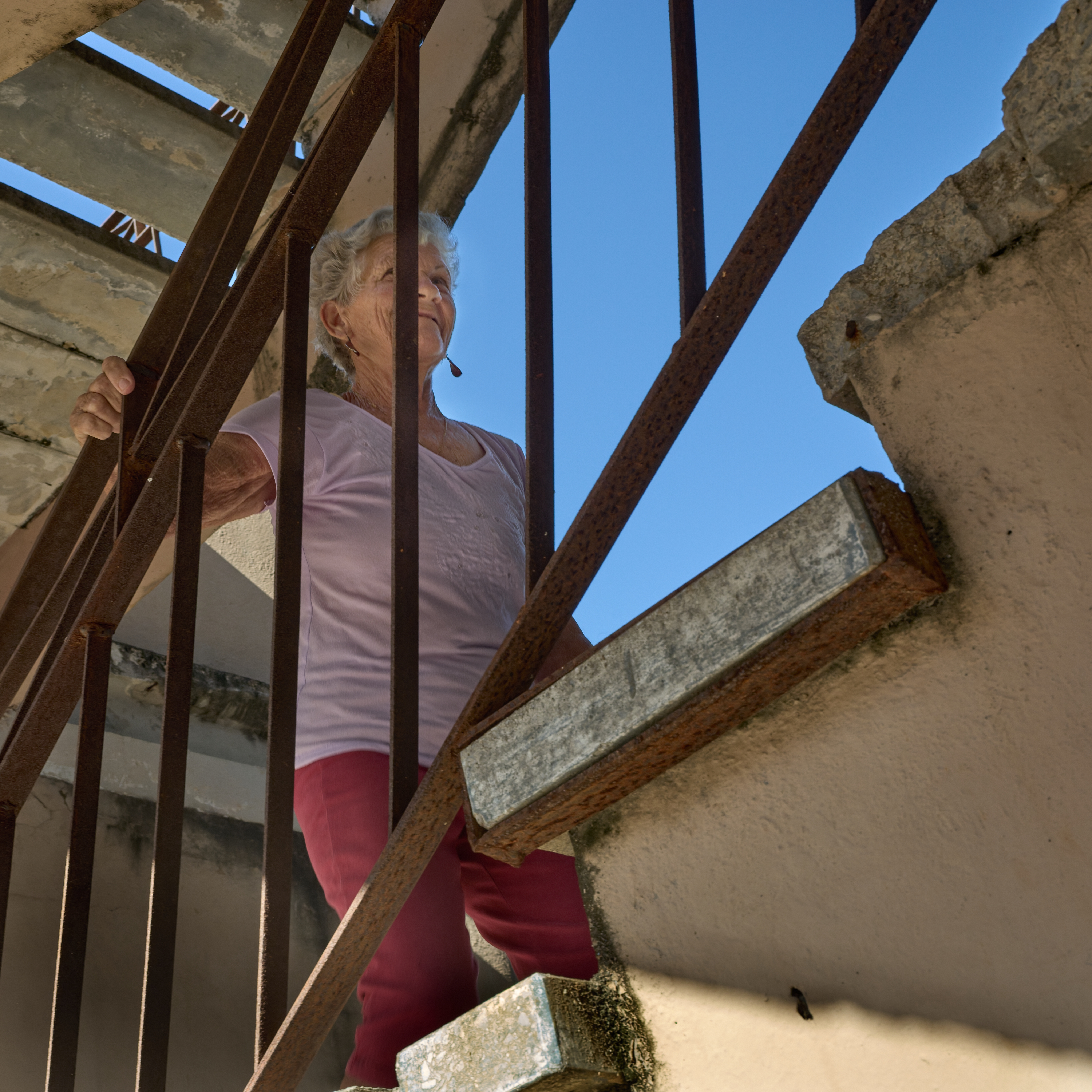 Stairway to Isolation    A narrow staircase leads to the couple’s second-floor, government-owned apartment. For the husband, it is a difficult barrier—he stays in the apartment all the time.
