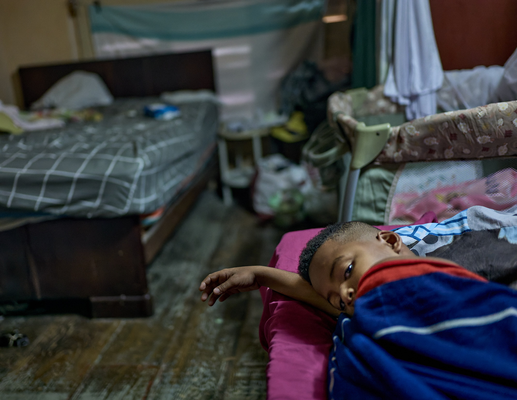 Alessandro lies sick in the cramped bedroom, sharing space with two beds and a crib. Dori believes school water made him ill — another failure of Cuba’s crumbling infrastructure. This is the only room for five people to sleep.