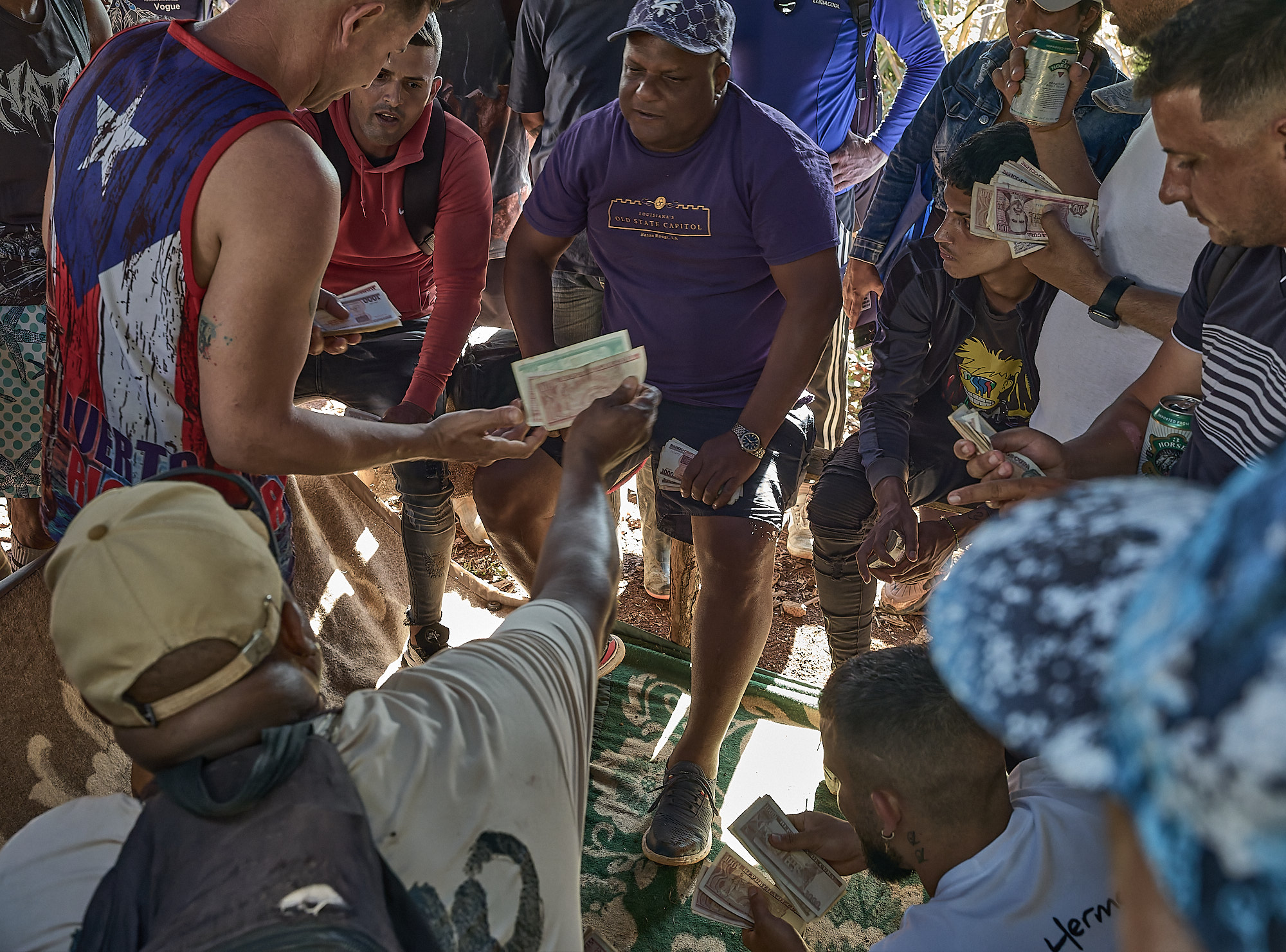 After each match, cash is exchanged among spectators. Informal betting is a central part of cockfighting culture in rural Cuba, reflecting both economic hardship and the deep local investment in these events.