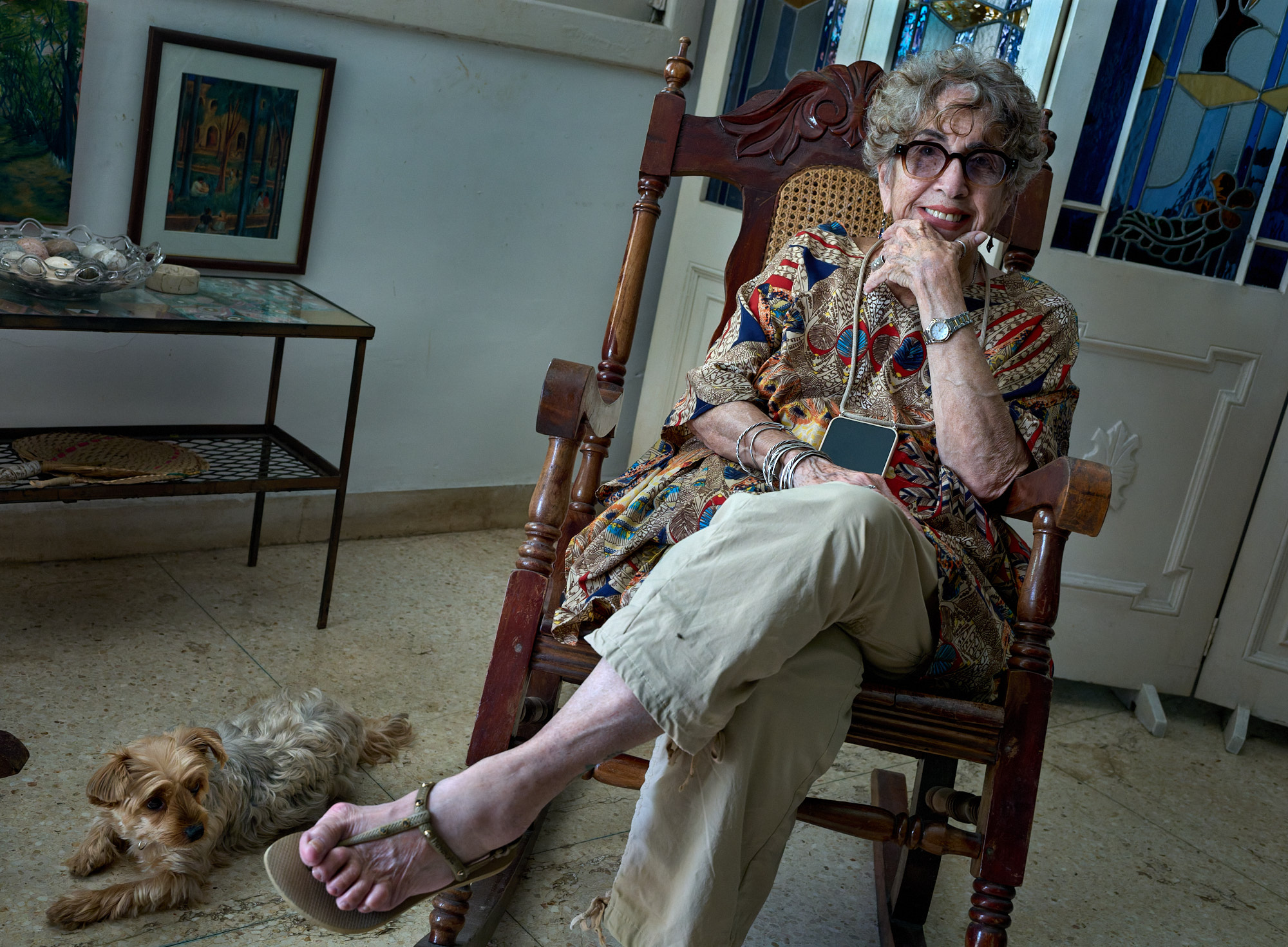 Ileana Yarza in her Havana home, the walls layered with fading memories of revolutions won and promises broken. From this chair, with her companion at her side, she recounted decades of struggle, pride, and survival in her own words.