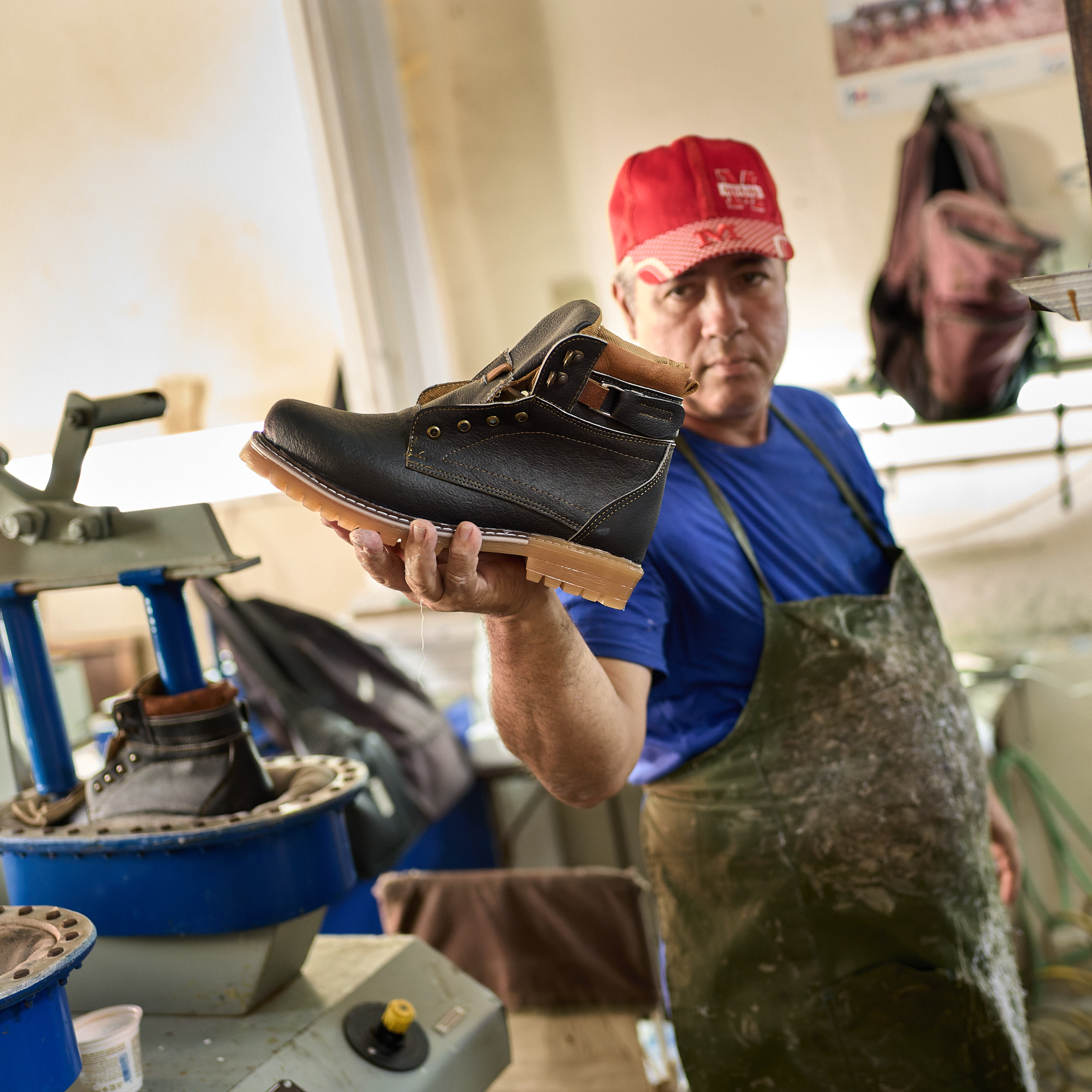 At Guazú, a worker proudly holds up a finished shoe, part of that model’s production run for the day. The small Santa Clara factory blends machines from Russia, China, and the 1960s, each still coaxed to life daily through skill and persistence.