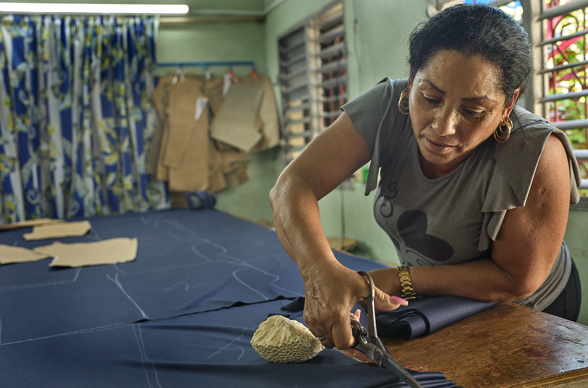 With quick, confident hands, Naomi is one of only two people in the workshop able to cut patterns precisely, a rare mastery of craft and intuition that can’t be taught, only earned through years of practice.