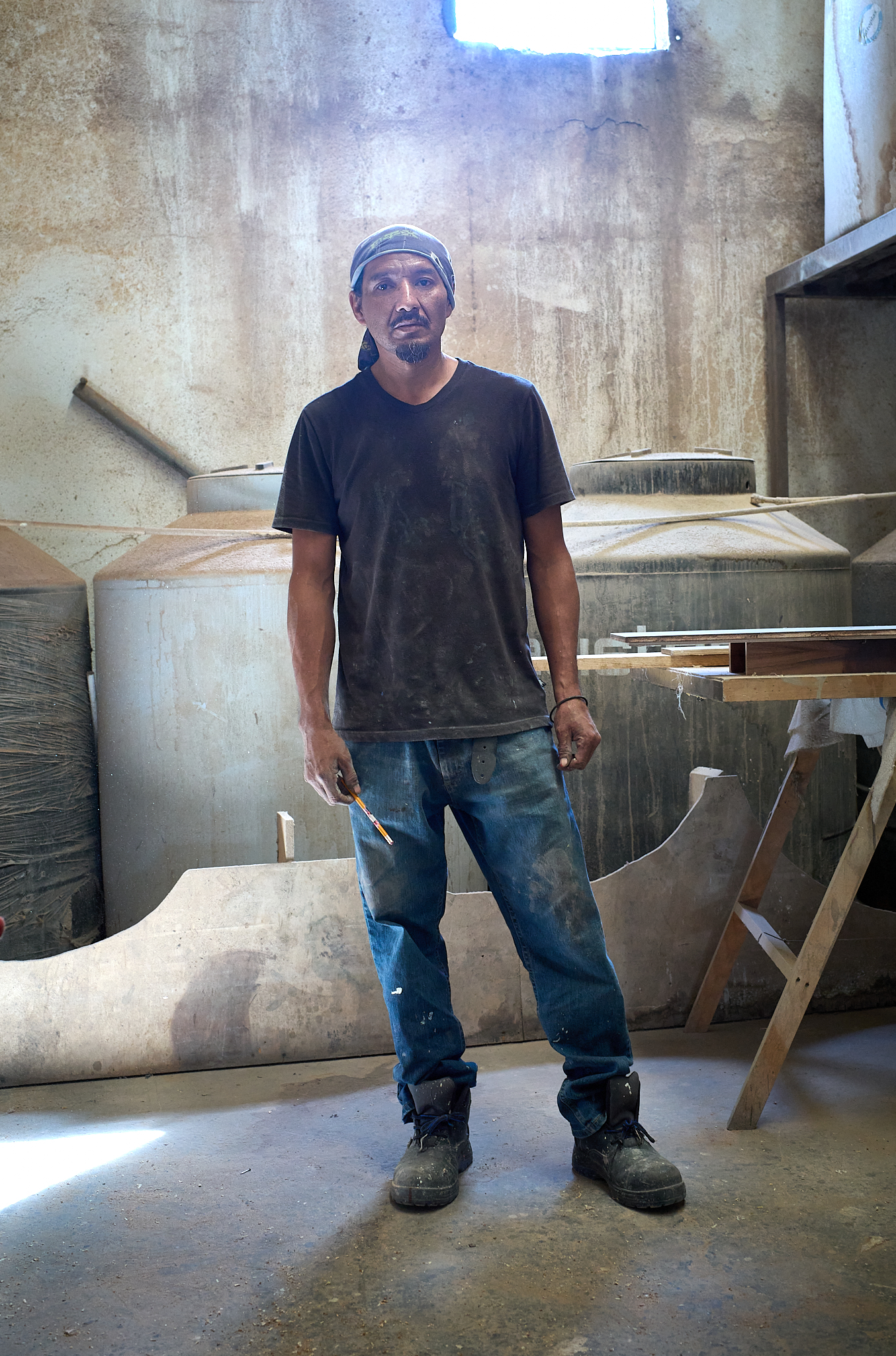A carpenter takes a moment for a portrait while working on the renovation of an interior space in Cabo San Lucas.