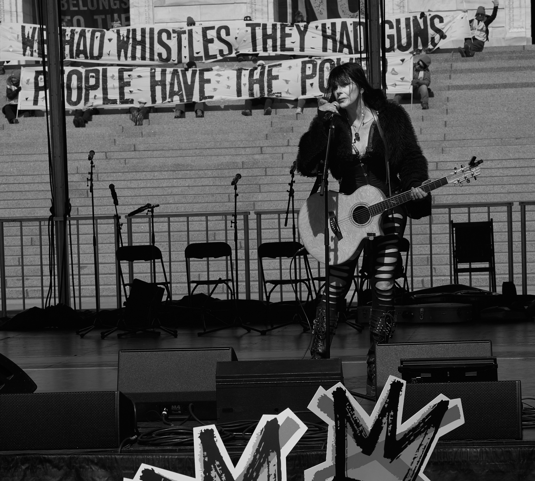 Venus DeMars performs during the “No Kings” rally at the Minnesota State Capitol in Saint Paul, Minnesota on March 28, 2026. DeMars, a Minnesota-based transgender musician and activist, delivered a live set as part of the rally supporting democracy, labor rights, and immigrant protections.