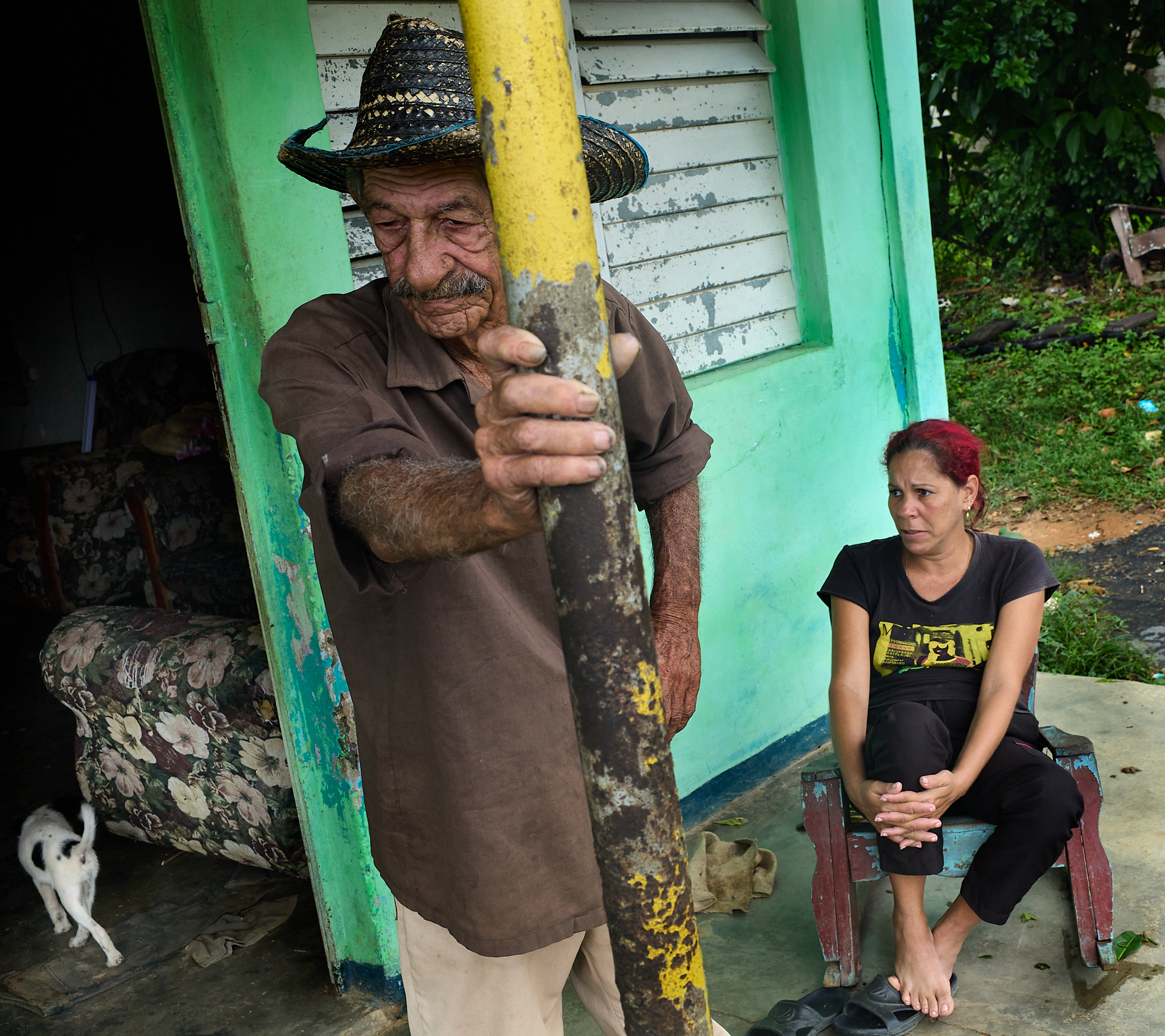 Miguel, the family patriarch, stands outside the house while Sisleidi, Michelle’s ex-wife, sits nearby.