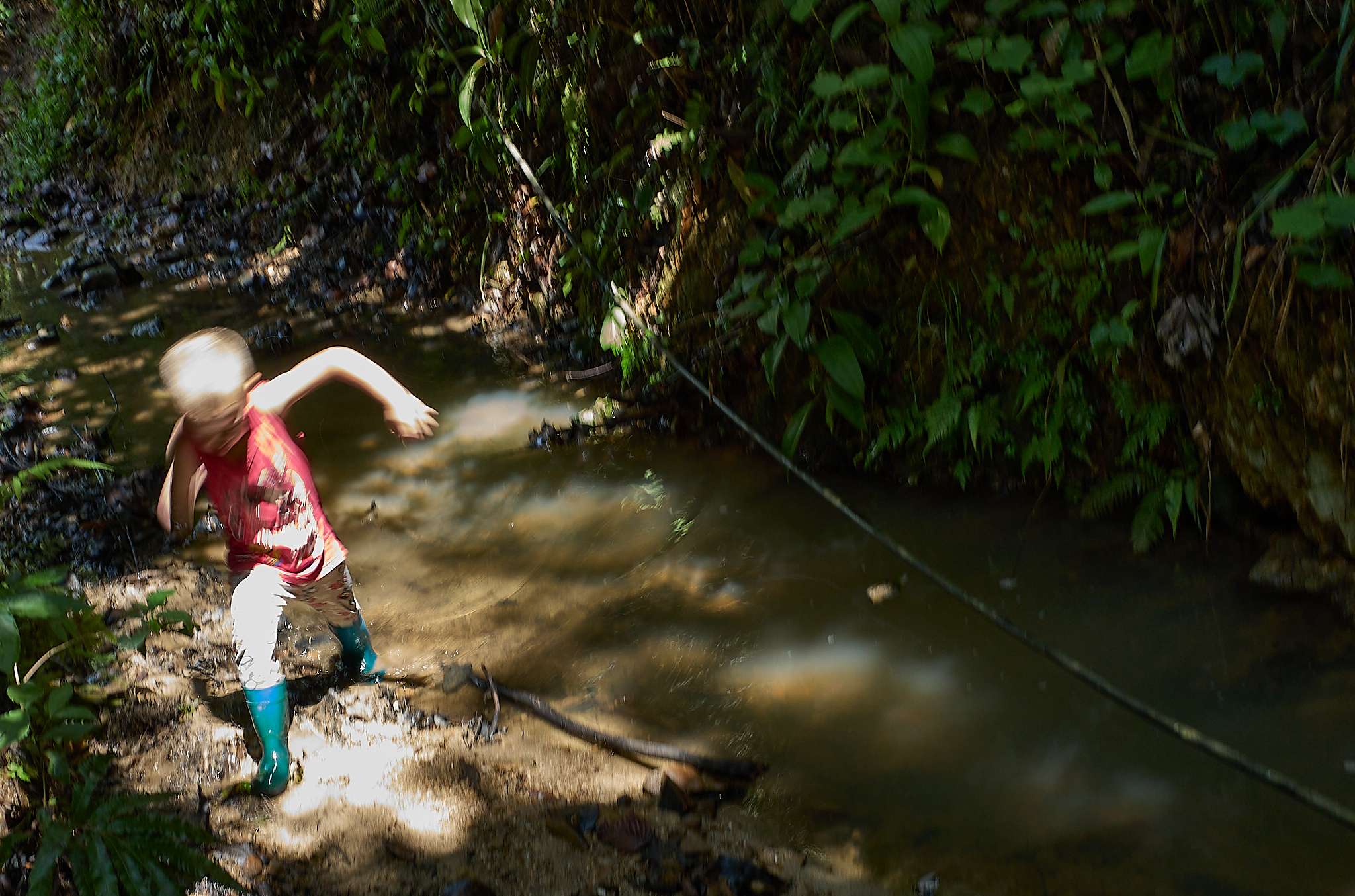 Michelle’s son plays near the headwaters of the spring that supplies drinking water to the village below. Hoses run from the hillside source down to homes throughout the valley using a simple gravity-fed system.